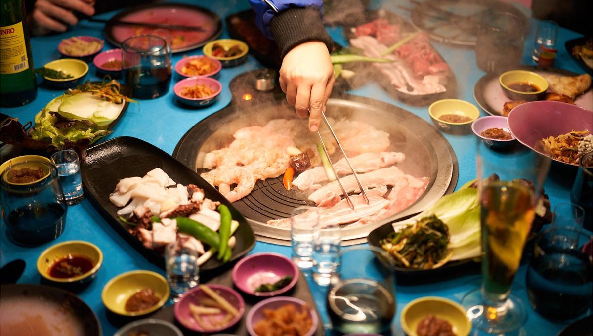 Food on the in-table grill at Gunbae Korean BBQ.