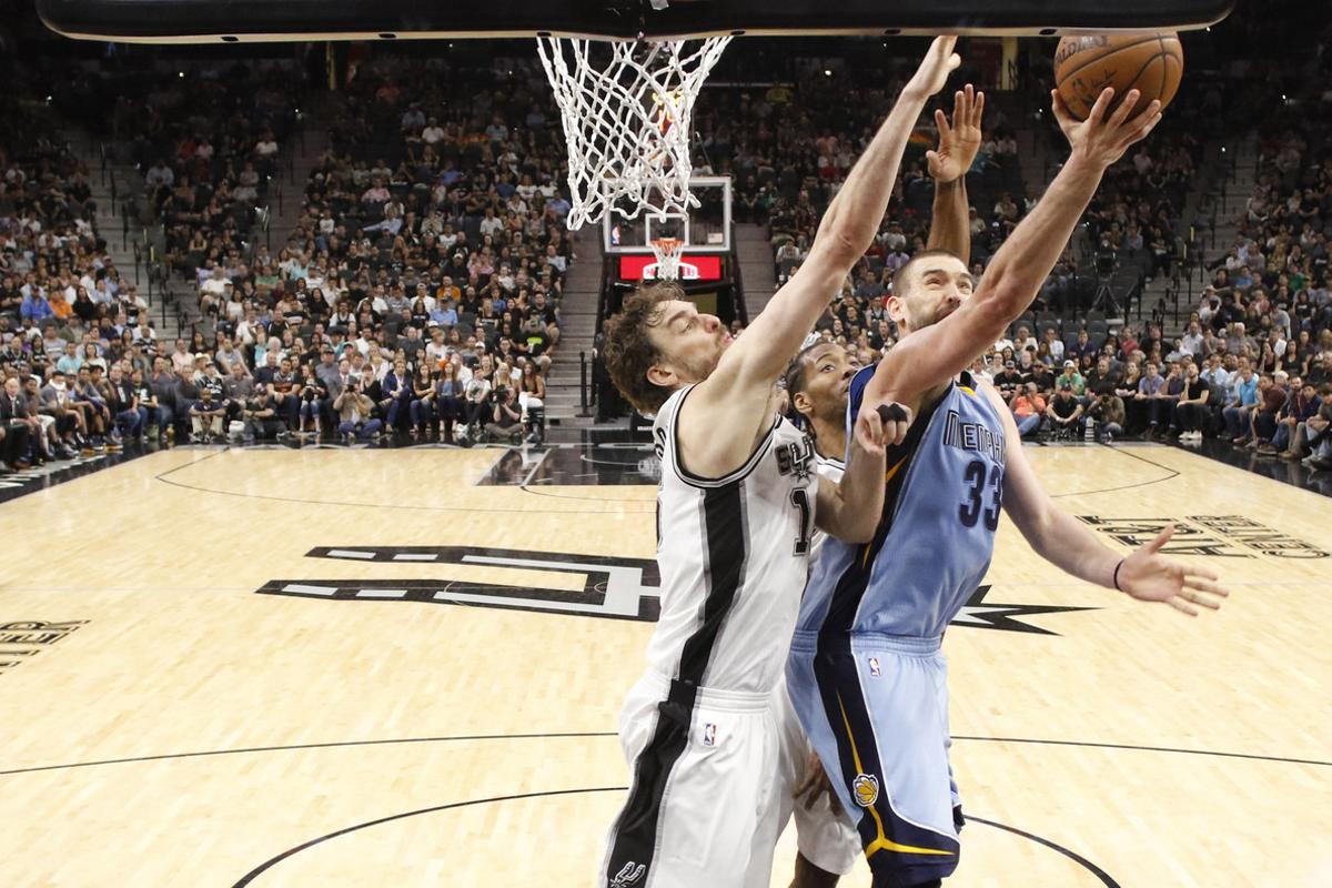 Apr 4, 2017; San Antonio, TX, USA; Memphis Grizzlies center Marc Gasol (33) shoots the ball as San Antonio Spurs center Pau Gasol (left) and Kawhi Leonard (behind) defend during the second half at AT&T Center. The Spurs won 95-89 in overtime. Mandatory Credit: Soobum Im-USA TODAY Sports