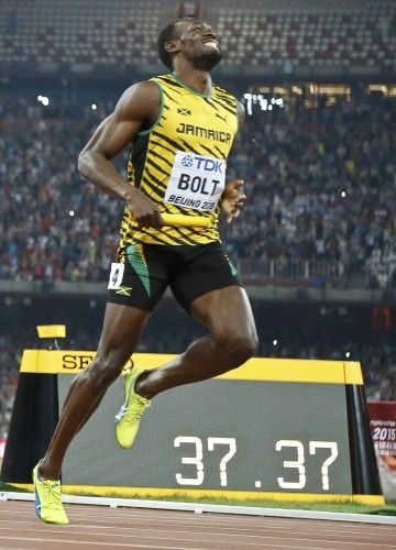 Bolt of Jamaica crosses to finish line to win the men's 4x100m relay during the 15th IAAF World Championships at the National Stadium in Beijing