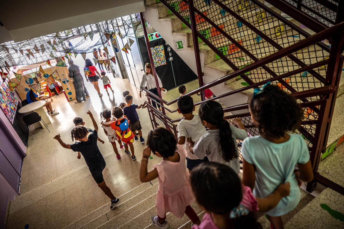 Un grupo de niños baja las escaleras de la escuela Lola Anglada de L'Hospitalet.