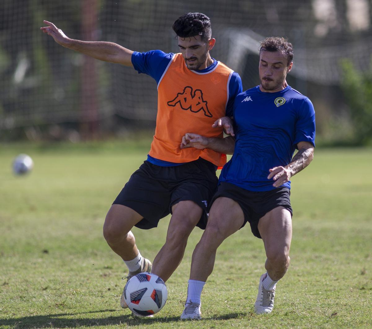 Alexandro Toscano pugna con Maxi Ribero por una pelota durante un entrenamiento.