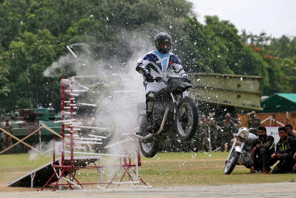 An army soldier rides through a wall of ...