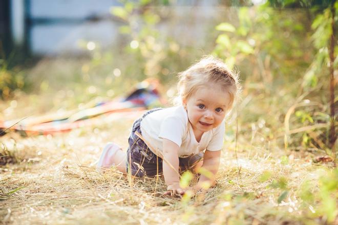 little girl crawling on the lawn