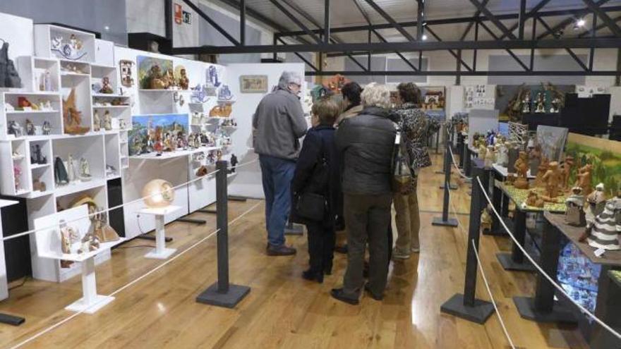 Un grupo de turistas disfruta de la exposición de belenes.