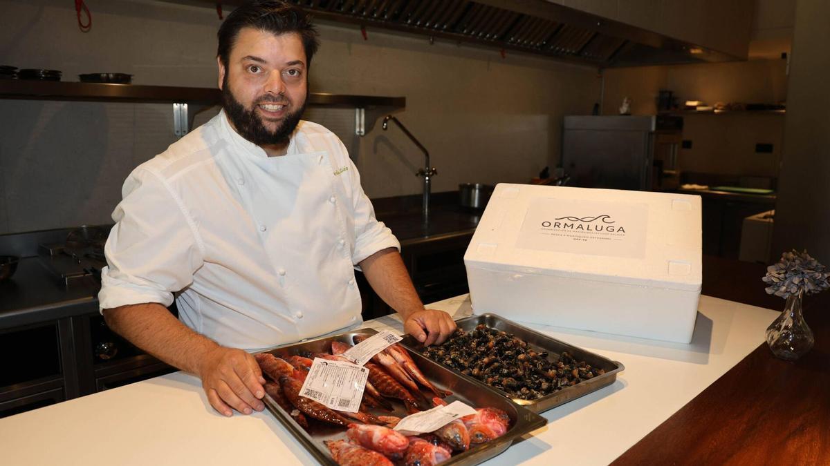 El chef Alberte Gutiérrez exhibe varias piezas de pescado y percebes enviados por Ormaluga, fundada por socios de cofradías de Galicia y Portugal.