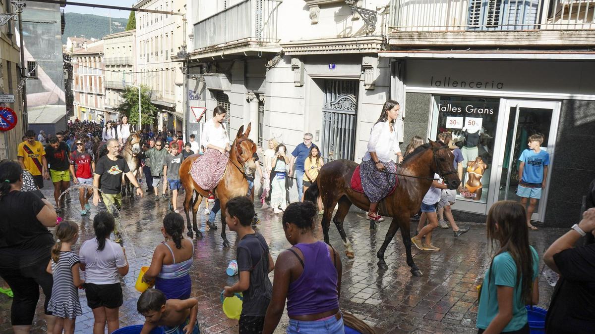 Durant la passada de cavalleries, és tradició ruixar amb aigua els animals i els genets