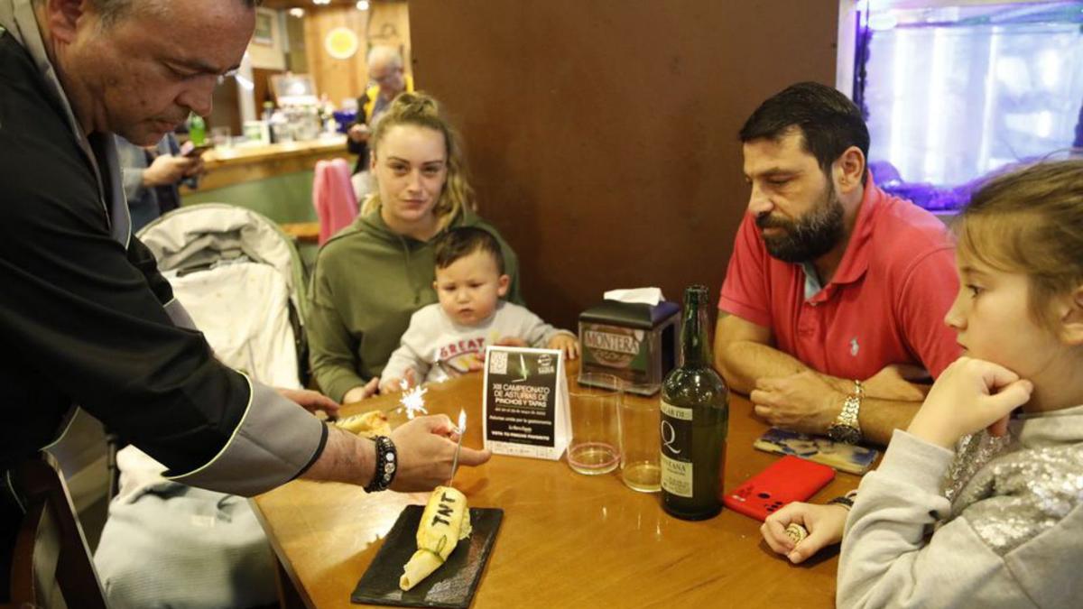 Una familia, a punto de disfrutar del pincho de La Montera Picona, en Gijón.  Ángel González