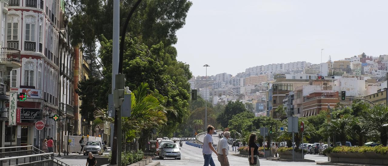 Peatones cruzan por el Guiniguada.