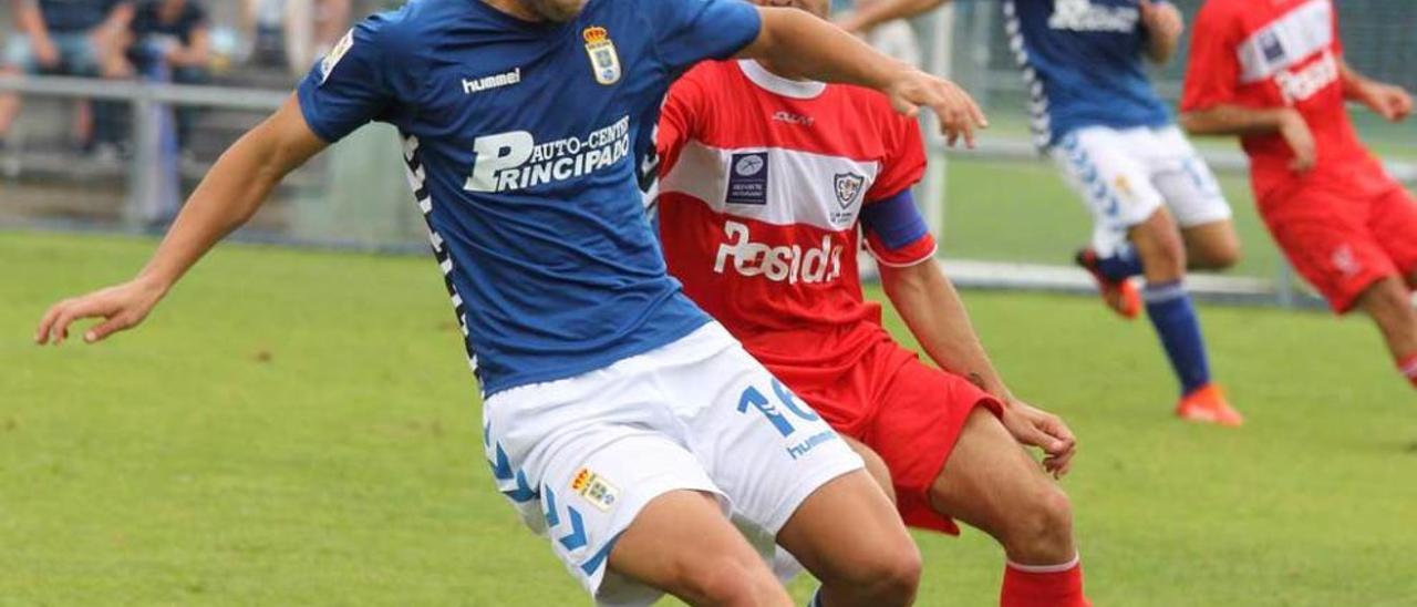 David Fernández intenta controlar el balón ante Guaya.