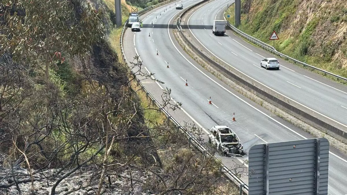 Un coche se incendia en la autopista y provoca un incendio forestal en Arteixo