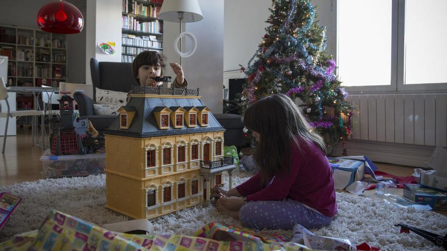 Niños abriendo juguetes en el día de Reyes.