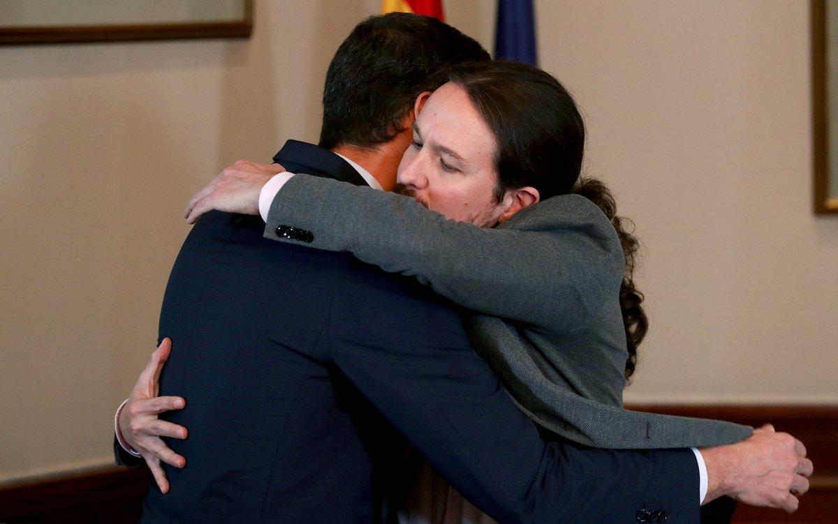 Spanish acting Prime Minister Pedro Sanchez and Unidas Podemos (Together We Can) leader Pablo Iglesias hug during a news conference at Spain’s Parliament in Madrid, Spain, November 12, 2019. REUTERS/Sergio Perez