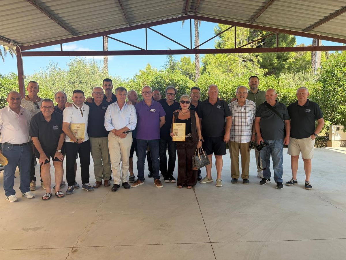 Foto de familia entre miembros de la Asociación de Amigos del Arroz Con Costra de Elche con sus invitados