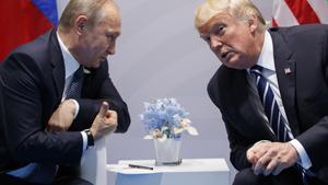 FILE - In this file photo taken on Friday, July 7, 2017, U.S. President Donald Trump, right, meets with Russian President Vladimir Putin at the G-20 Summit in Hamburg, Germany. The Kremlin said Trump called Putin to congratulate him on re-election, and White House press secretary Sarah Huckabee Sanders confirmed that Trump spoke with Putin Tuesday March 20, 2018. (AP Photo/Evan Vucci)