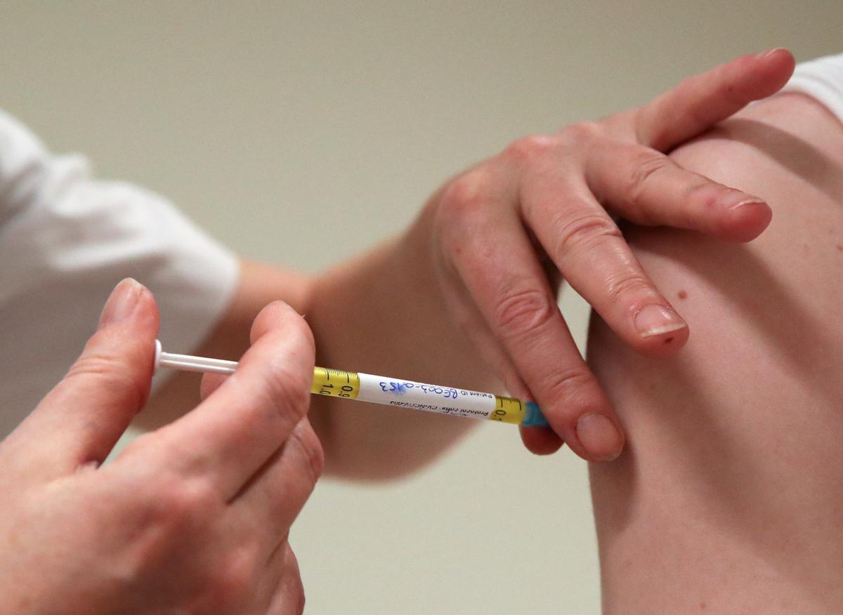 A volunteer receives a dose of CureVac vaccine or a placebo, in Brussels