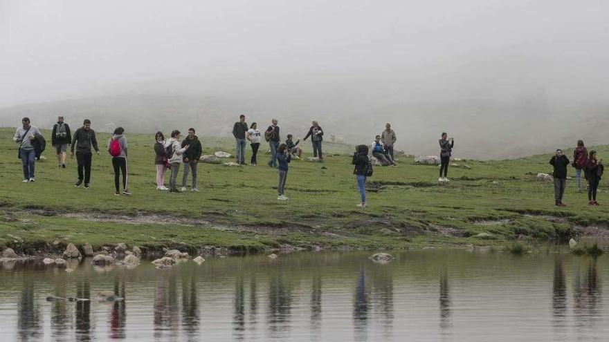 Turistas este verano, entre la niebla, en los lagos de Covadonga.