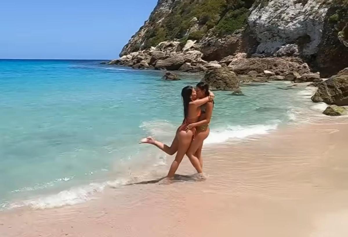 La influencer y su pareja a orillas de una playa pitiusa