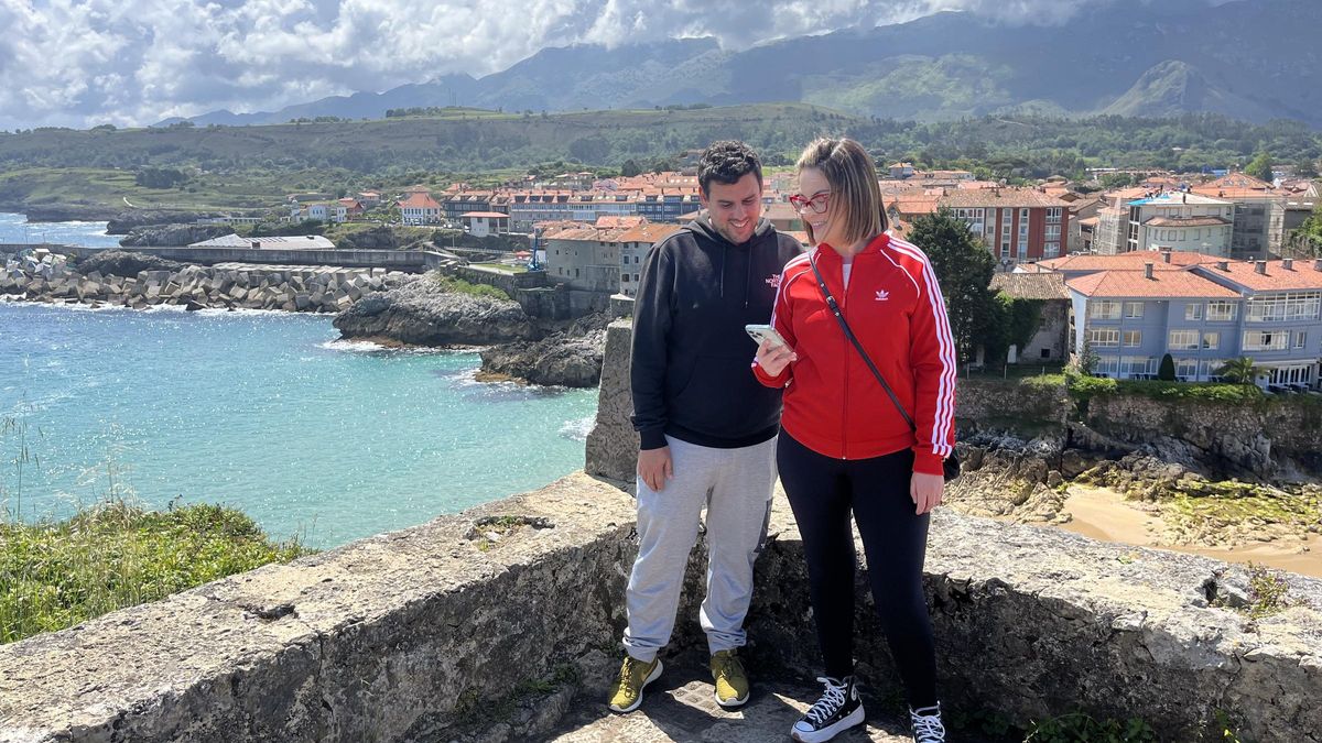 Aitor Rodríguez y María Pérez, vecinos de Palencia, consultando información en su terminal desde el paseo de San Pedro