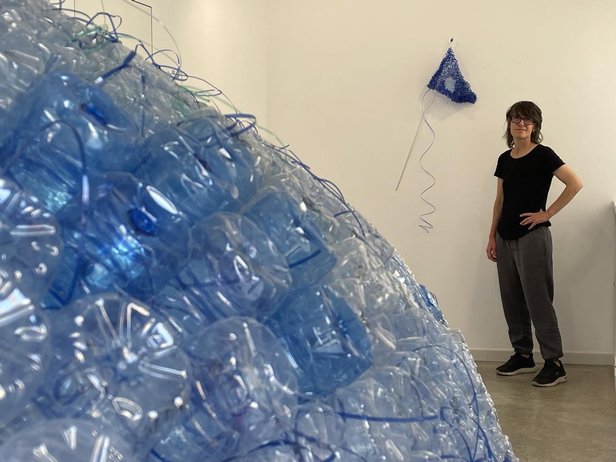 La artista con la bandera creada para esta exposición.