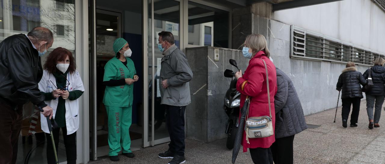 Pacientes esperan para vacunarse a las puertas del centro de salud de La Calzada.