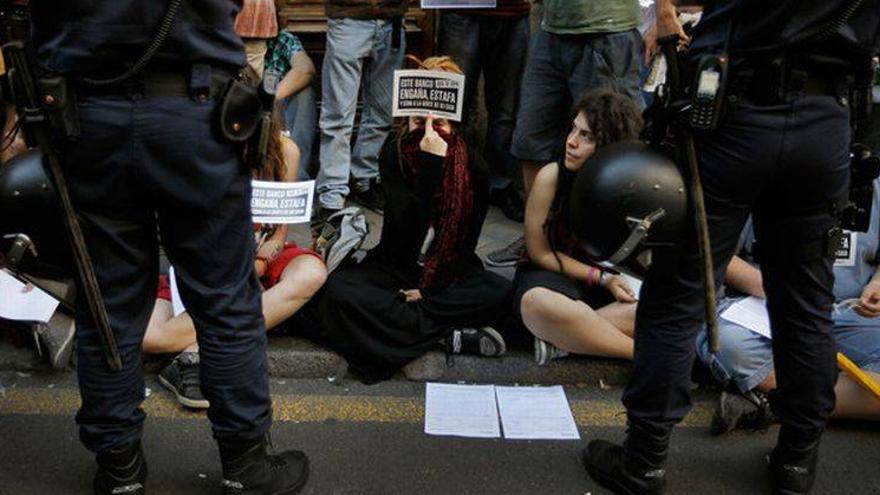 Decenas de personas exigen la dación en pago frente a una sucursal de Bankia en Madrid
