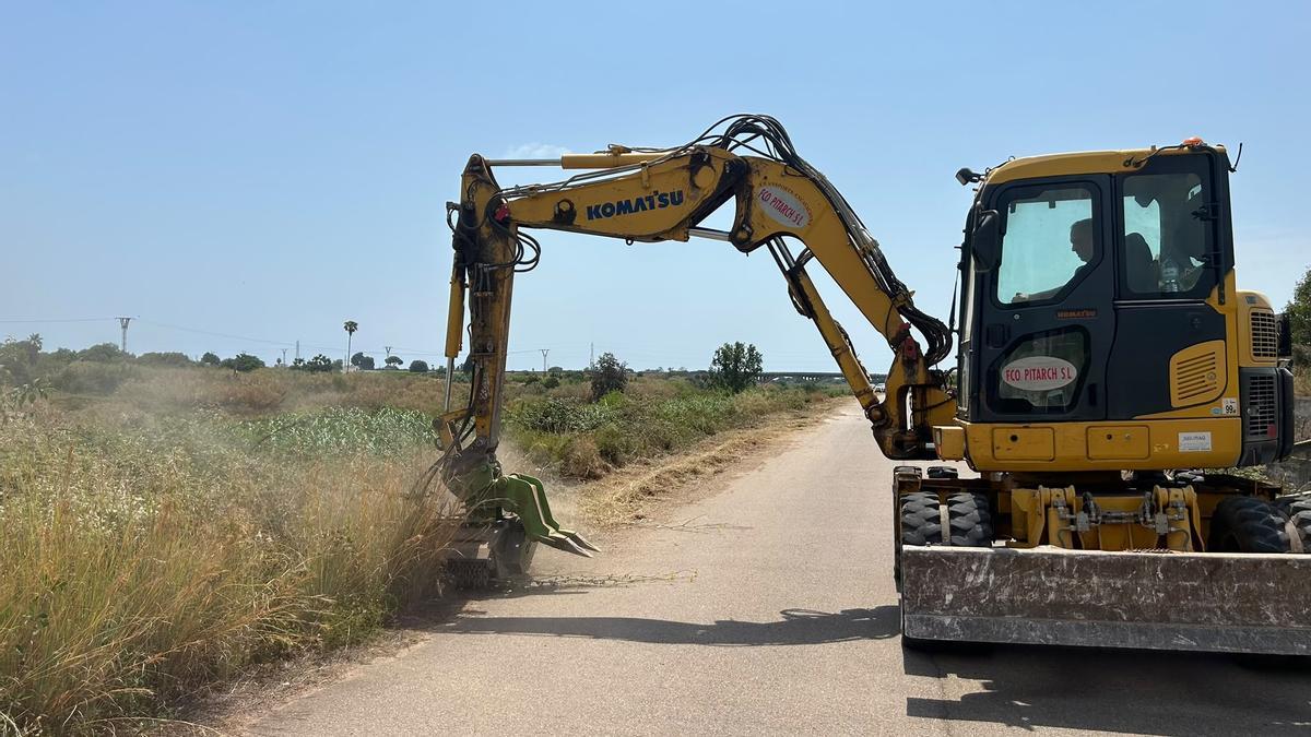 Una máquina trabaja para desbrozar una parcela en el término municipal de Vila-real.