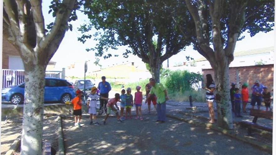 Mayores y niños juegan a la petanca