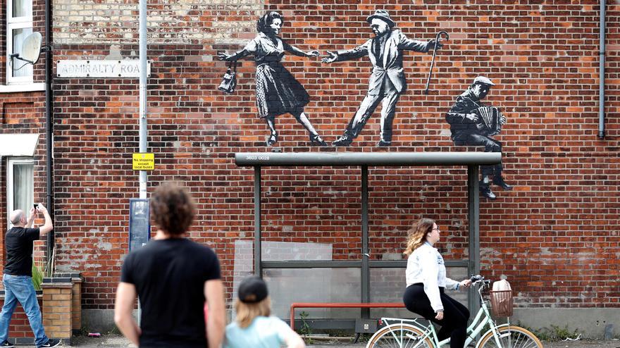 People stop to look at artwork believed to be created by Banksy in Great Yarmouth