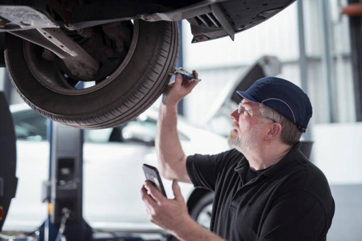 Mechanic checking the tires of a vehicle