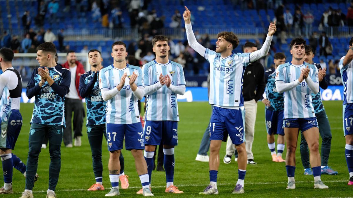 Los jugadores del Málaga CF celebran la victoria con la afición.