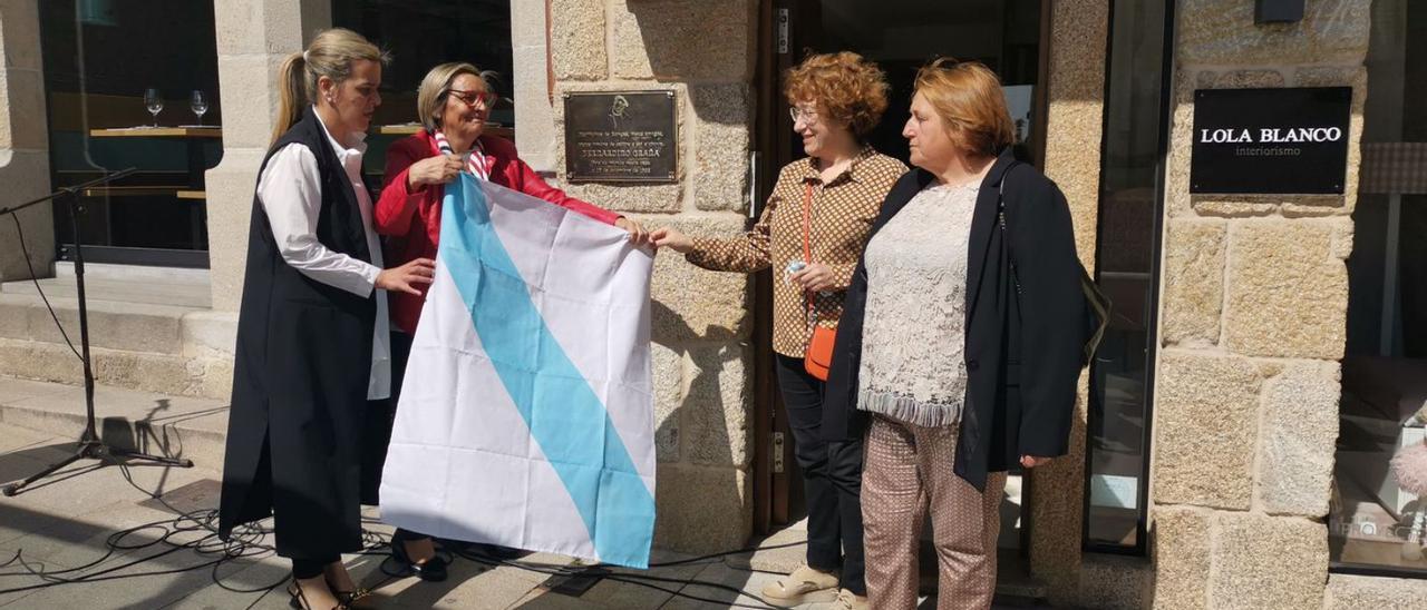 Prieto recoge la bandera que tapaba la placa conmemorativa junto a las ediles de la oposición