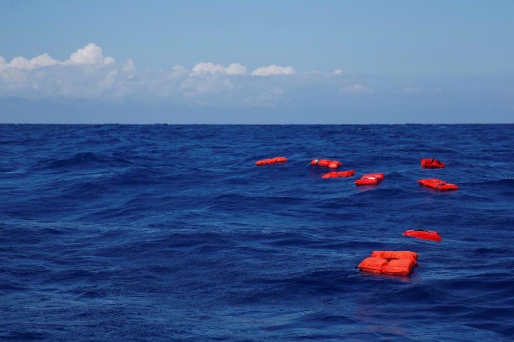 Life jackets float on the water during a ...