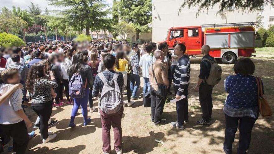 Los desalojados, en el exterior del instituto junto a un camión de bomberos.