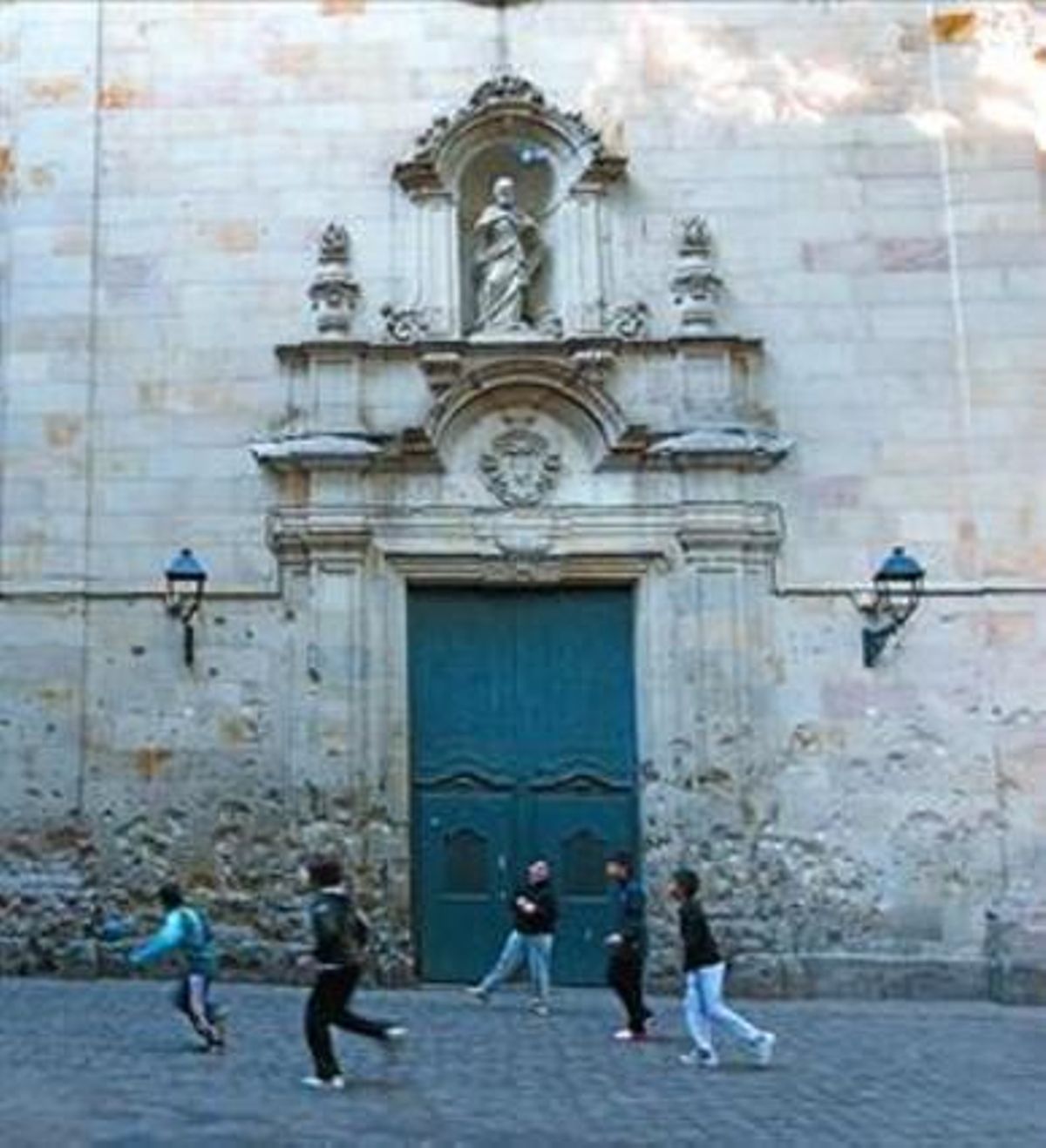 La plaça8 Uns nens juguen davant de l’església de Sant Felip Neri.