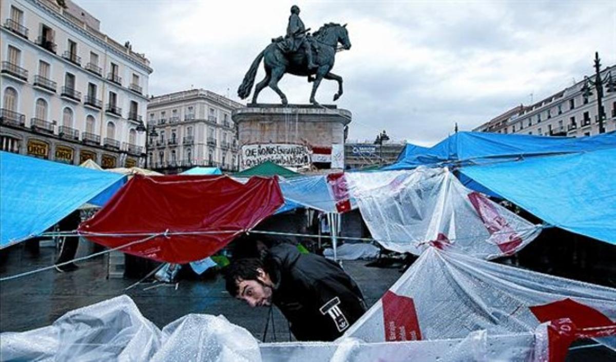 Els indignats es protegeixen de lapluja dijous passat.