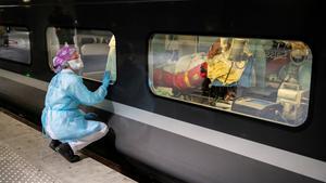 A medical staff looks through the window of a TGV high speed train before its departure to evacuate patients infected with the COVID-19 from Paris region hospitals to Brittany, as the spread of the coronavirus disease continues, in Paris, France April 1, 2020. Picture taken April 1, 2020. Thomas Samson/Pool via REUTERS