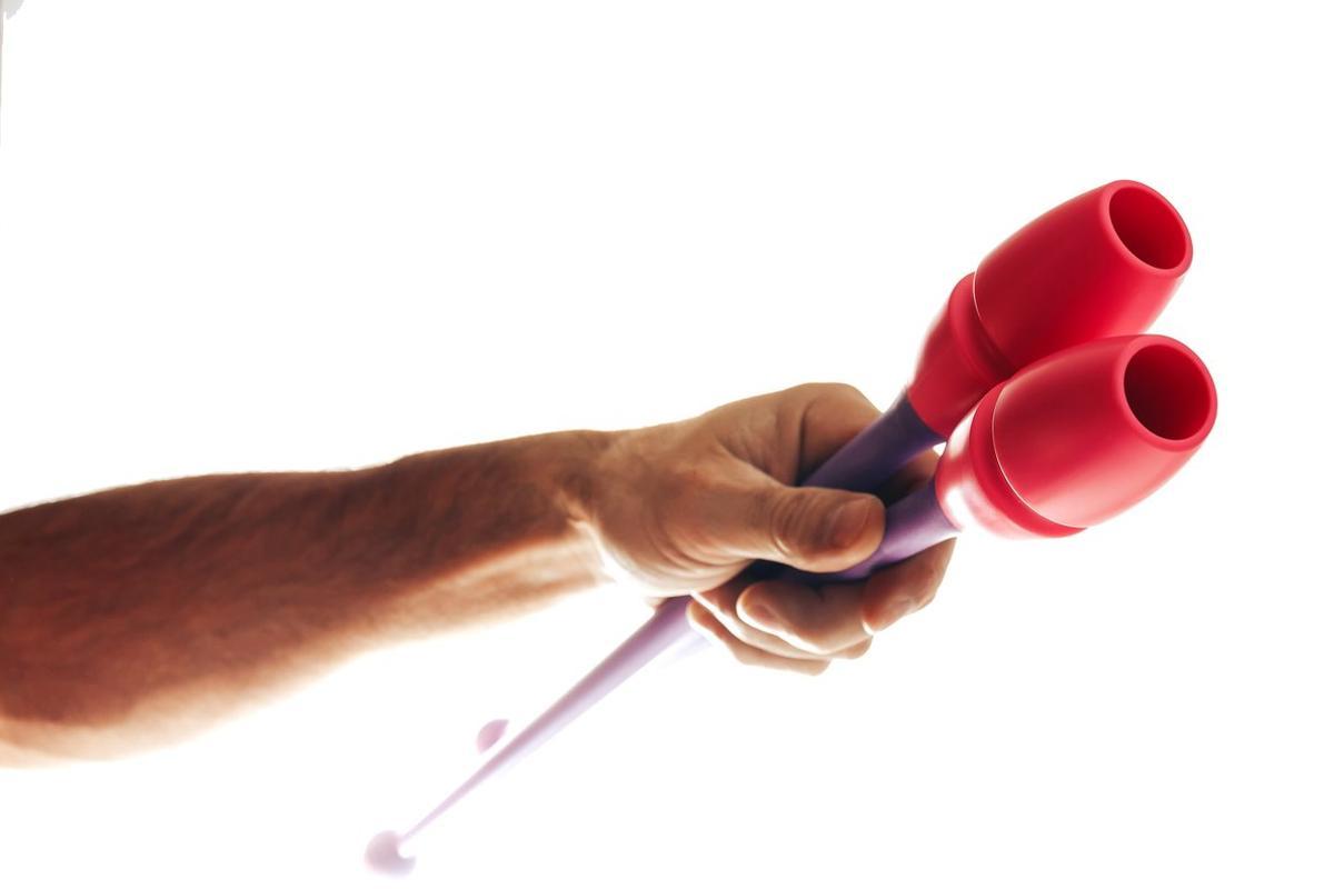 FOTO BAJADA DE 123RF EL 27 DE JUNIO DEL 2019. man’s hand holds maces for rhythmic gymnastics. UN BRAZO DE HOMBRE SOSTIENE UNAS MAZAS DE GIMNASIA RITMICA. DEPORTE, GIMNASIA, RITMICA, MAZA, MAZAS. FOTO DE 123RF.