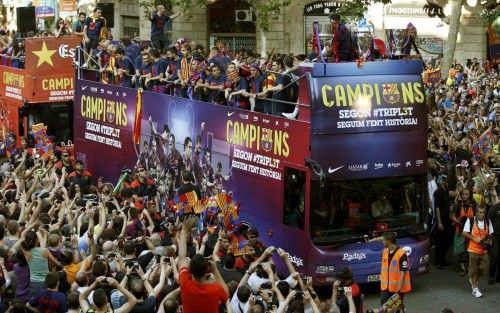 Barcelona's players celebrate from an open-top bus during celebration parade in Barcelona