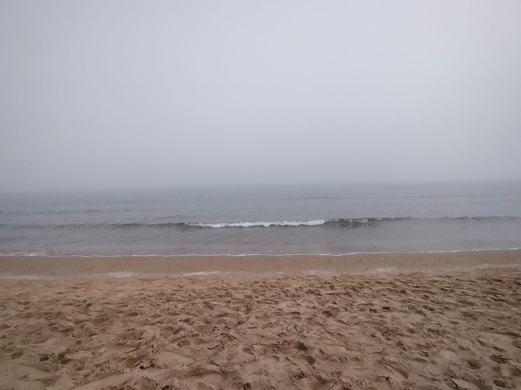 La playa de Gandia desaparece entre la niebla