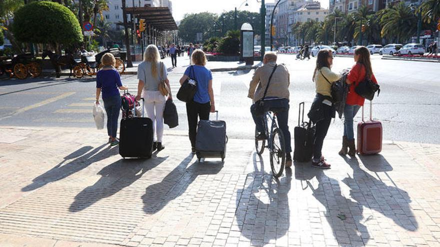 Turistas con sus maletas en el Centro de Málaga.