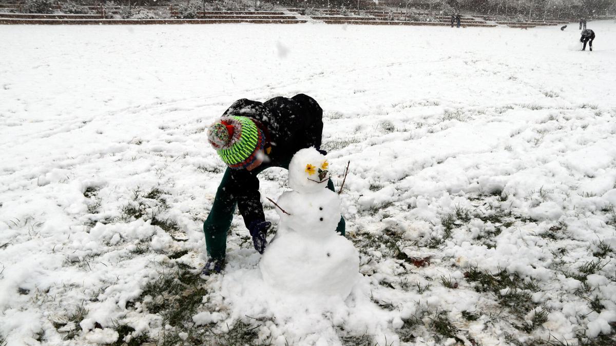 Las familias juegan con la nieve en el Parc Central de Igualada.