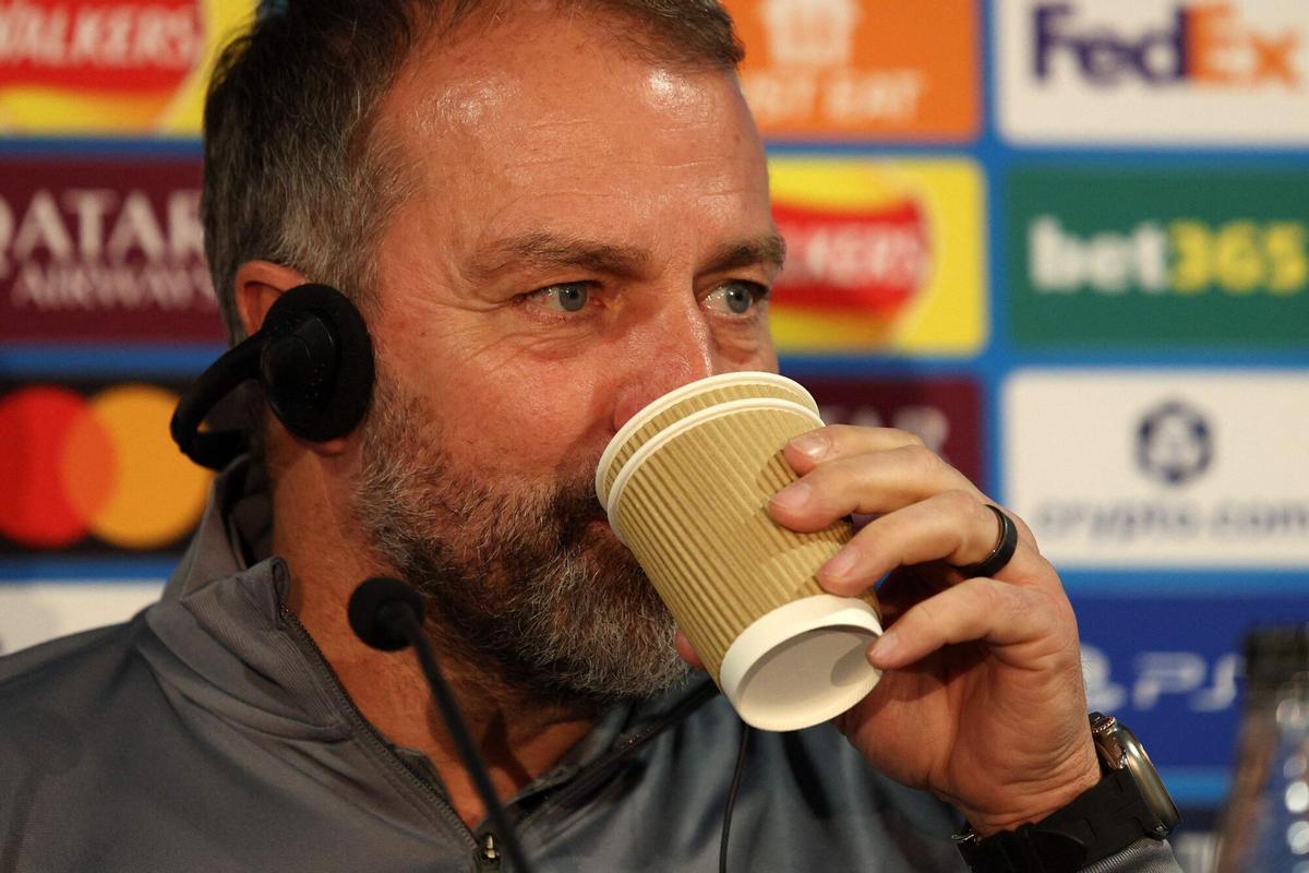 Barcelona's German coach Hans-Dieter Flick sips a drink during a press conference at Stamford Bridge in London on November 24, 2025, on the eve of their UEFA Champions League league phase football match against Chelsea. (Photo by Adrian DENNIS / AFP)
