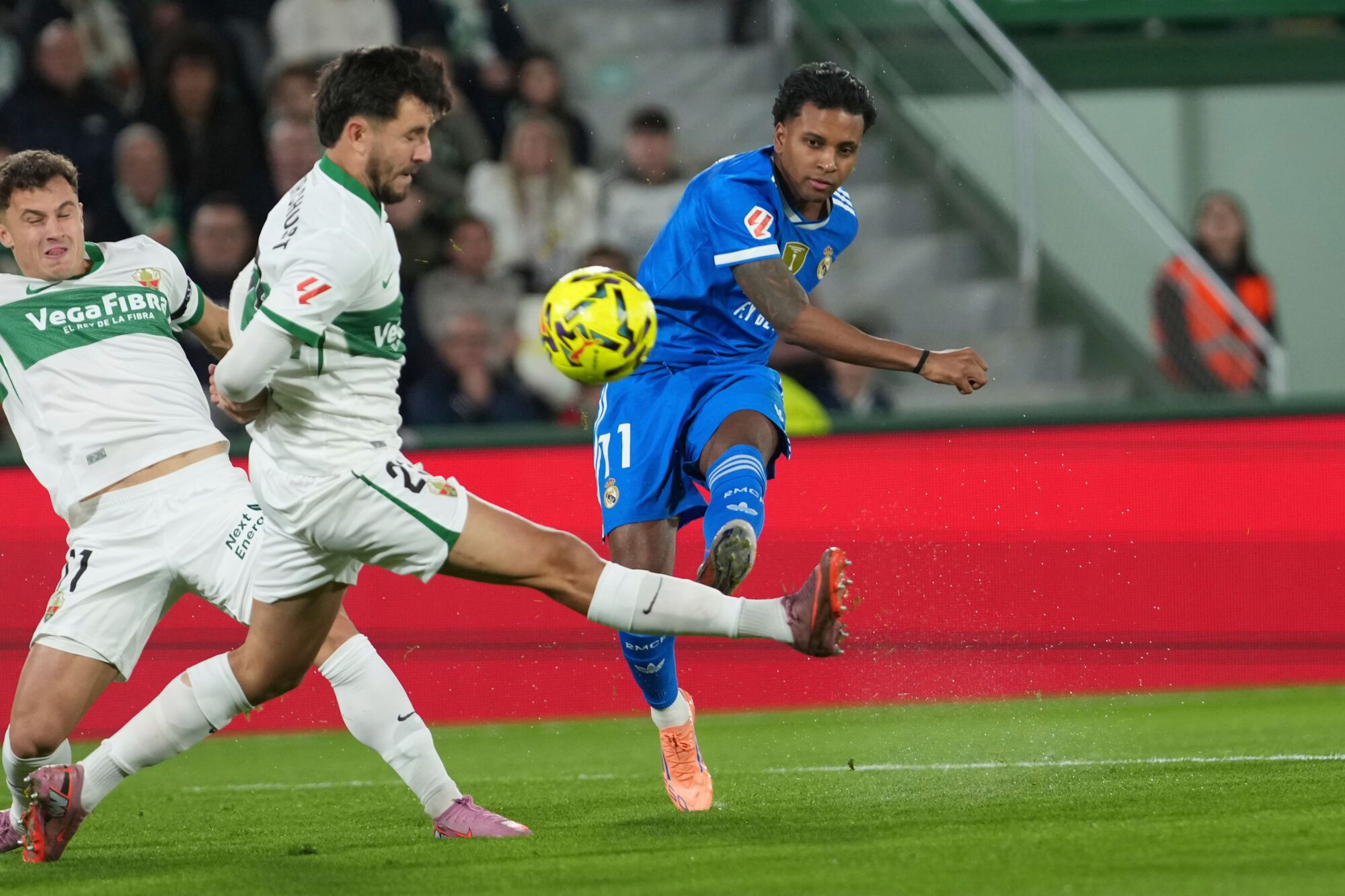 Real Madrid's Rodrygo, right, and Elche's Victor Chust challenge for the ball during the Spanish La Liga soccer match between Elche and Real Madrid in Elche, Spain, Sunday, Nov. 23, 2025. (AP Photo/Alberto Saiz)