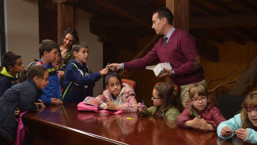 El alcalde repartiendo bolígrafos a los niños del colegio Los Salados.