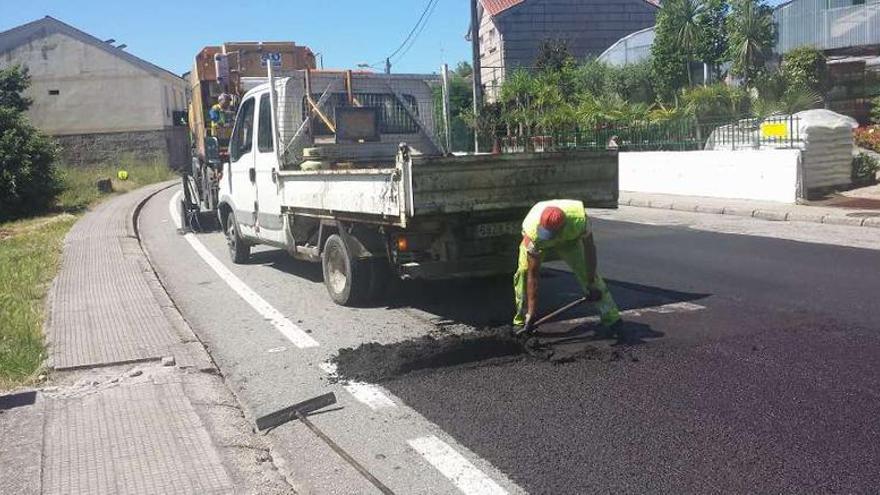 Un operario asfaltando el carril en sentido a Vigo.