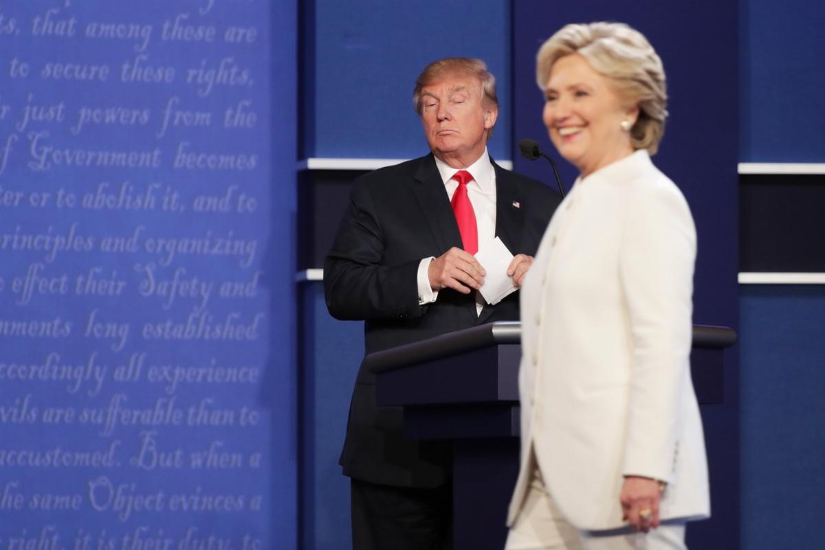 LAS VEGAS, NV - OCTOBER 19: Democratic presidential nominee former Secretary of State Hillary Clinton walks off stage as Republican presidential nominee Donald Trump looks on during the third U.S. presidential debate at the Thomas & Mack Center on October 19, 2016 in Las Vegas, Nevada. Tonight is the final debate ahead of Election Day on November 8.   Chip Somodevilla/Getty Images/AFP