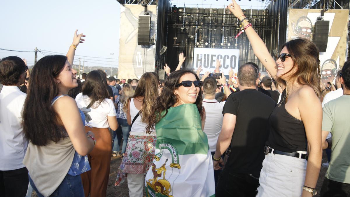 Imagen de tres asistentes, una de ellas con la bandera andaluza, este viernes en Extremúsika.