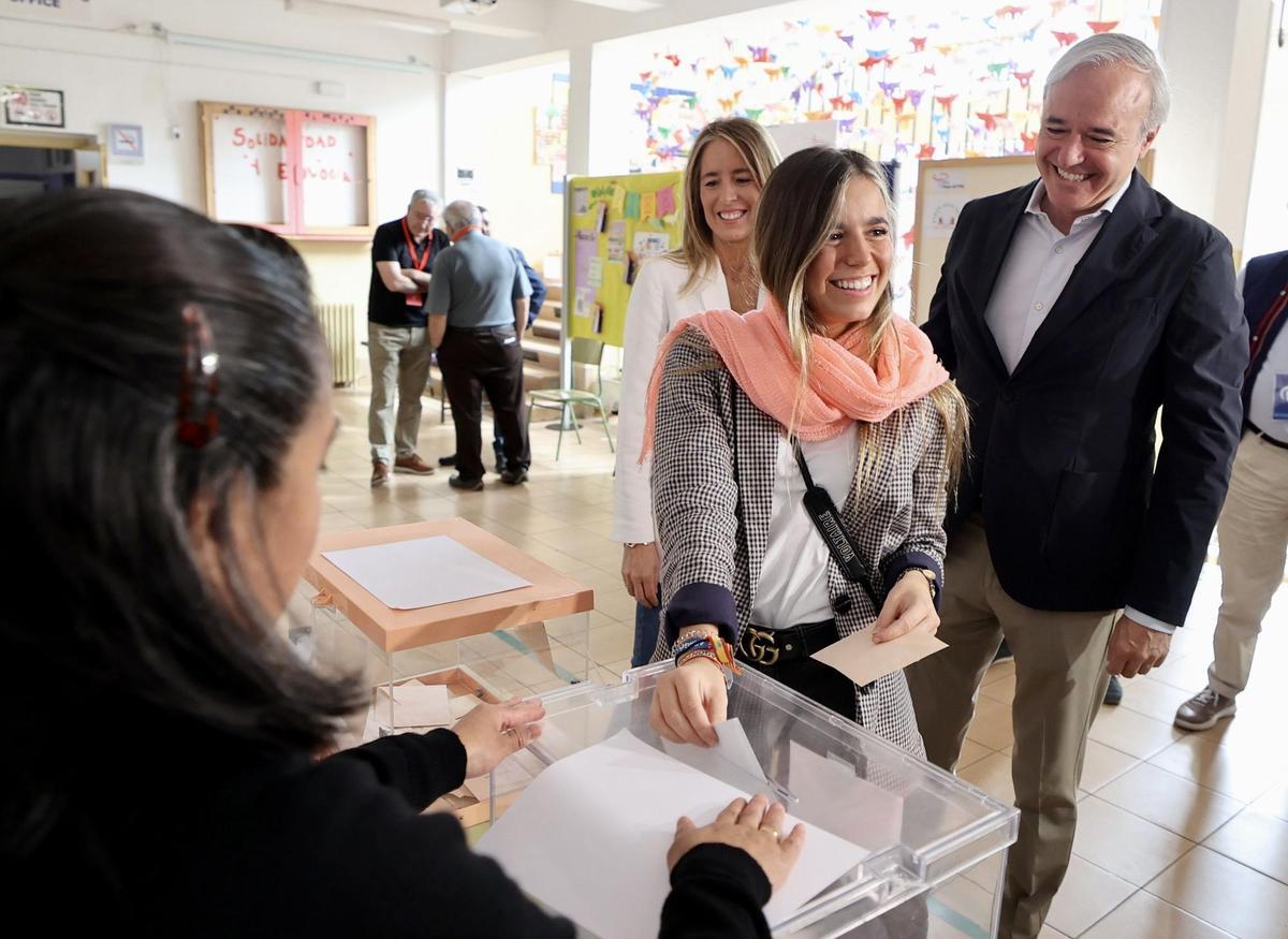 El candidato del PP a la Presidencia, Jorge Azcón, detrás de su hija, de 18 años, que votaba por primera vez, este domingo.