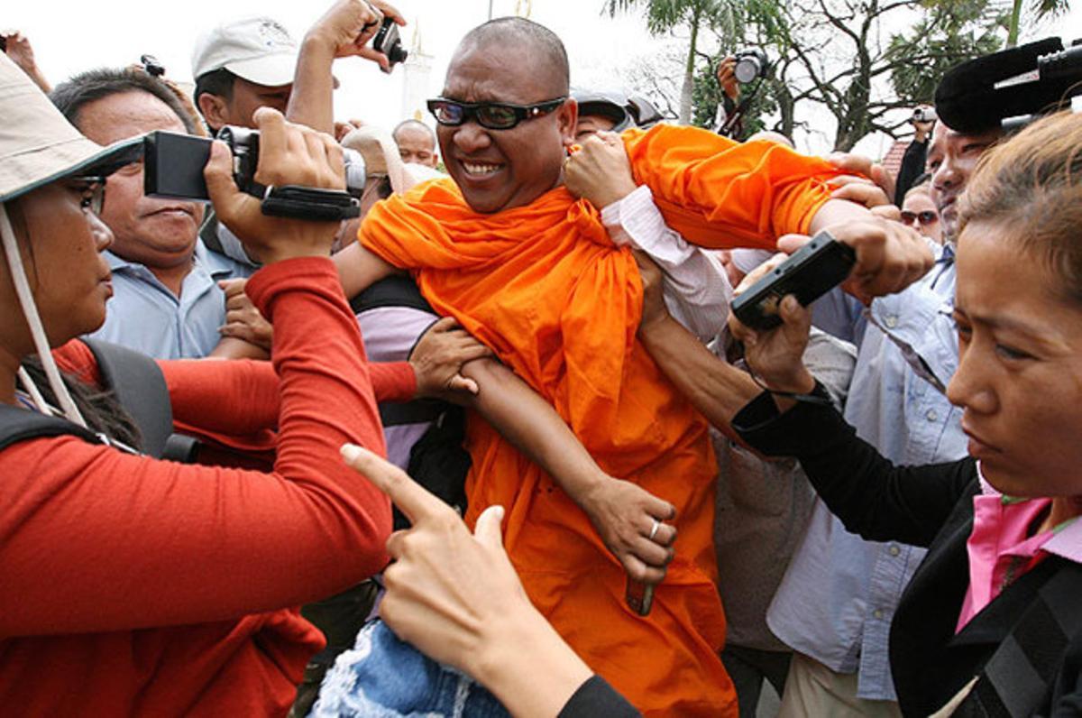 Diversos agents de policia detenen un monjo budista, durant una manifestació davant dels jutjats per protestar i demanar al tribunal que alliberi els companys arrestats en una una altra protesta, a Phnom Penh (Cambodja).