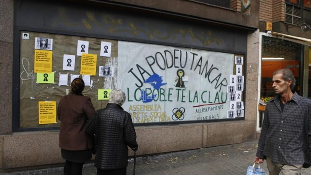 Carteles de la 'okupación' desde fuera de la oficina a la que han entrado los activistas.